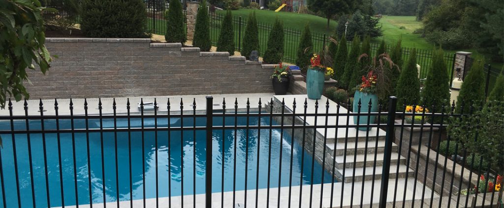 residential pool fence with hardscaping