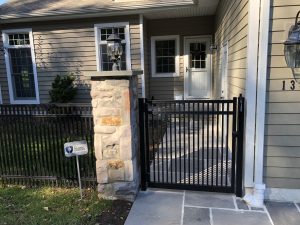 residential aluminum fence inspiration with stone column