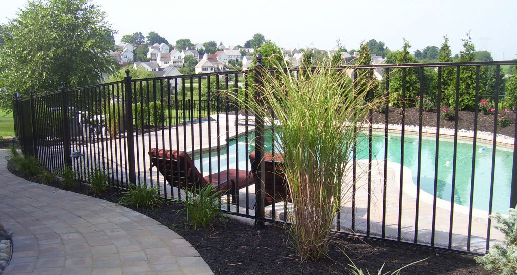 Black aluminum pool fence with landscaping