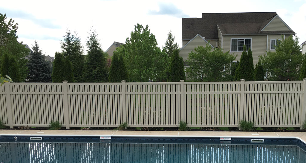 Tan vinyl pool fence for privacy