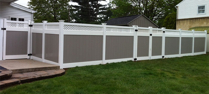 Grey privacy fence with lattice top