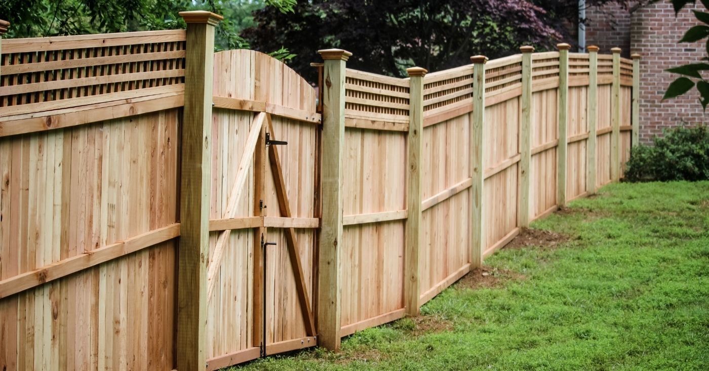 Cedar wood fence on slanted backyard