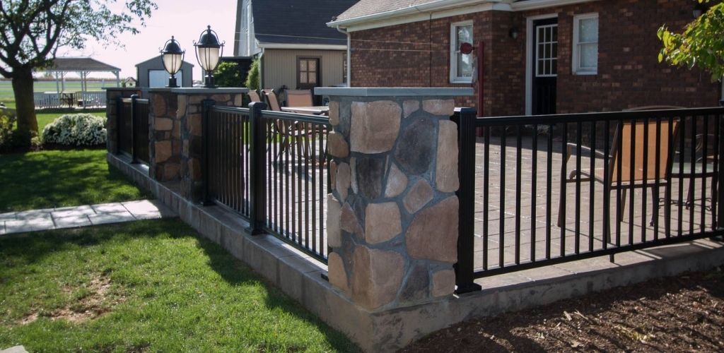 deck railing style shown in aluminum with stone pillars