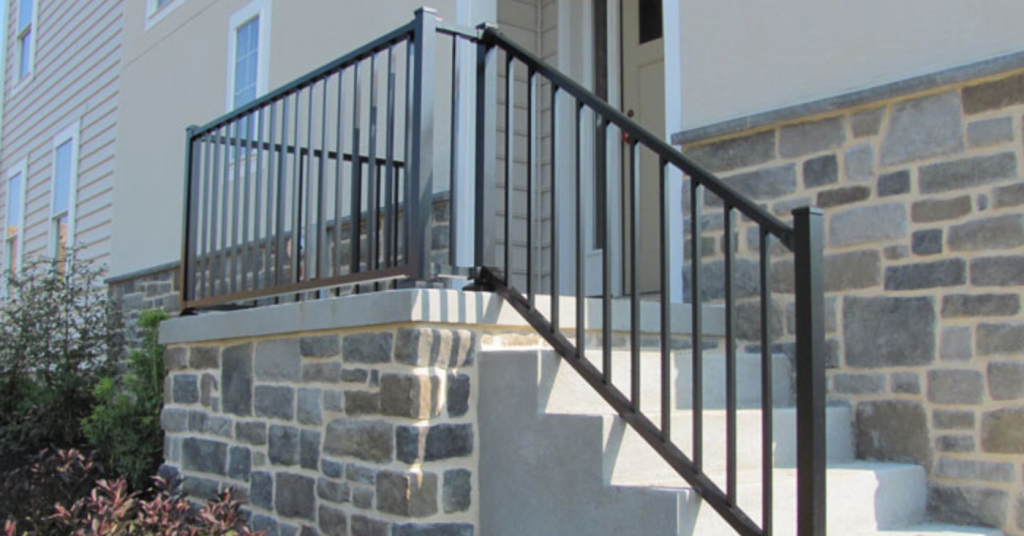 vinyl or aluminum railings for concrete stairs in front of stone home
