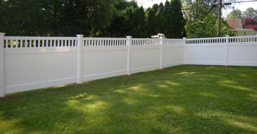 white vinyl modern fence design surrounding backyard