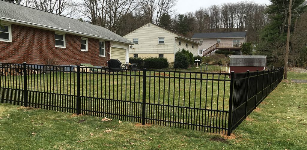 Black metal fence style in backyard of suburban home in PA