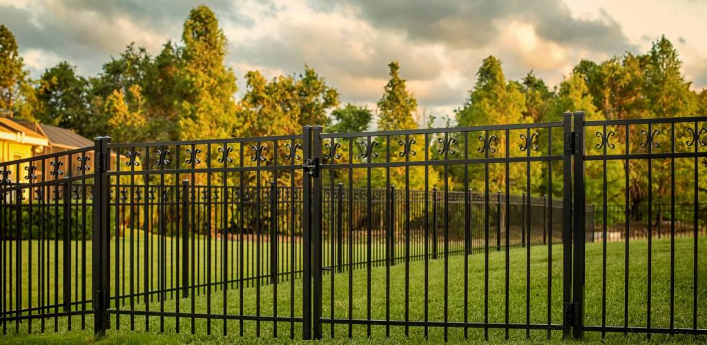 most durable fence material showing black aluminum fence and sky